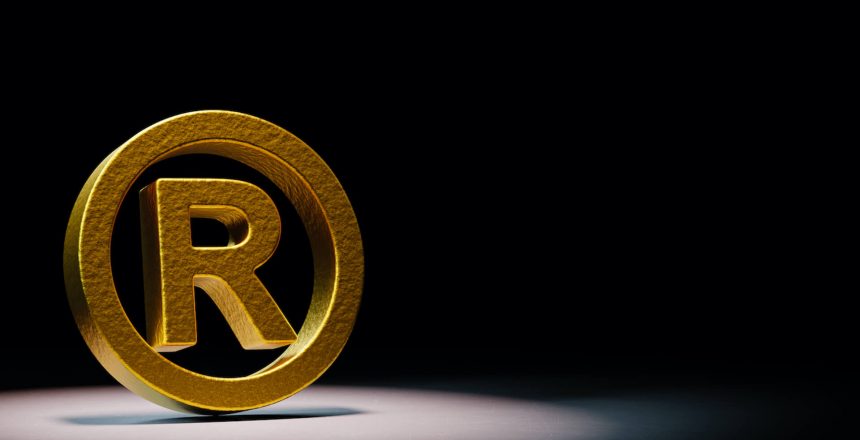 golden-trademark-symbol-spotlighted-black-background(2)